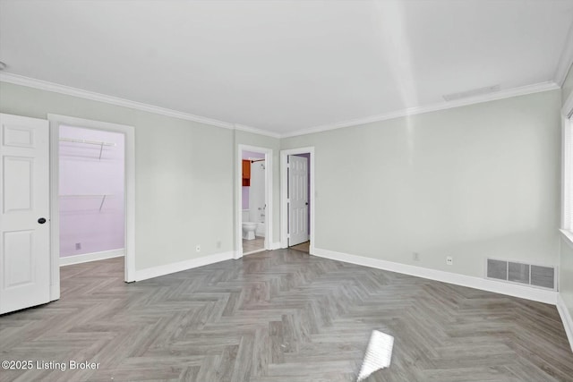 interior space featuring visible vents, crown molding, and baseboards