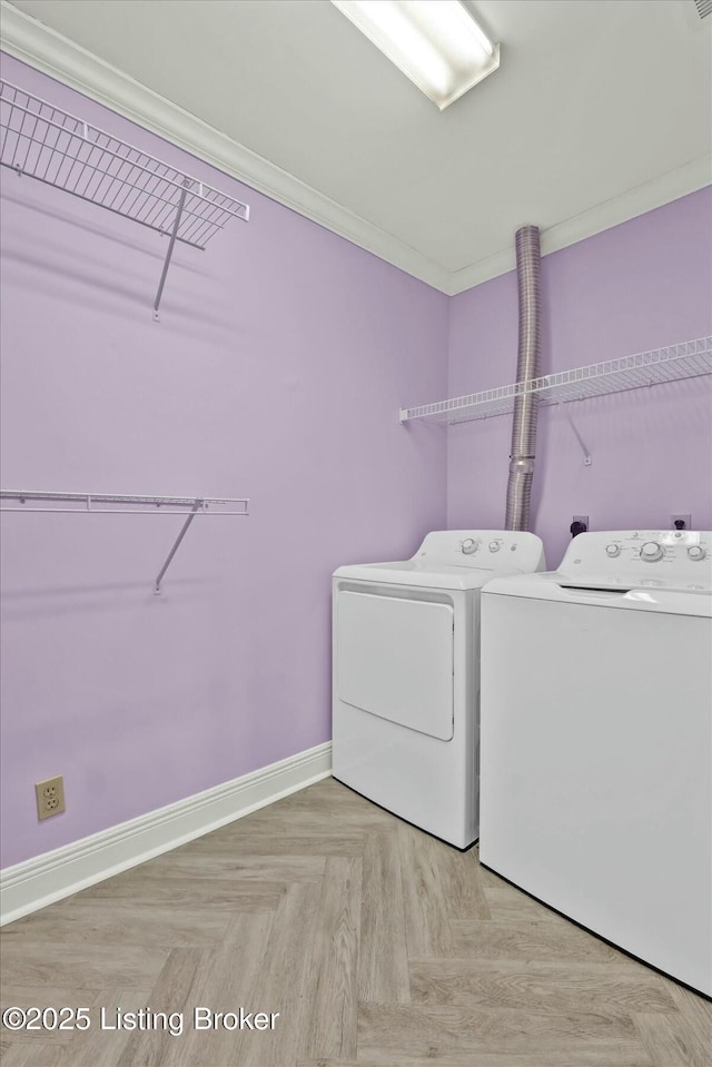 washroom featuring baseboards, laundry area, ornamental molding, and washer and dryer