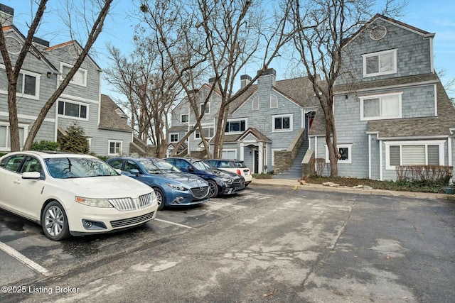 uncovered parking lot with a residential view