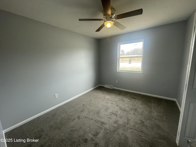 empty room featuring ceiling fan, baseboards, visible vents, and dark colored carpet