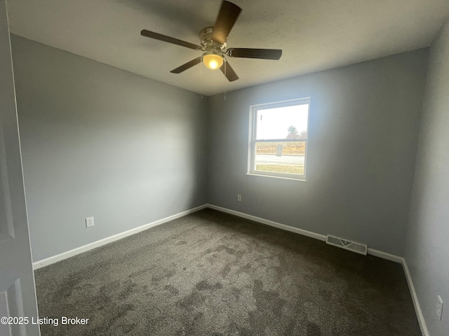 empty room with ceiling fan, baseboards, visible vents, and dark colored carpet