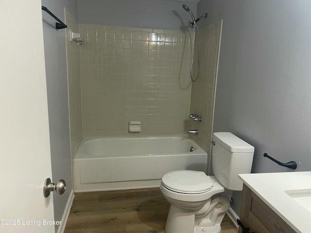 bathroom with  shower combination, vanity, toilet, and wood finished floors