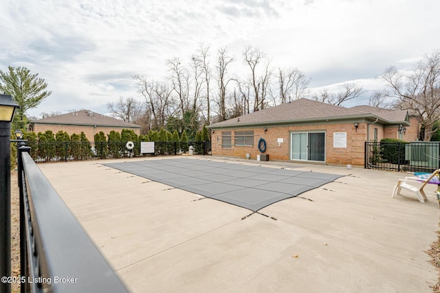 pool featuring fence and a patio