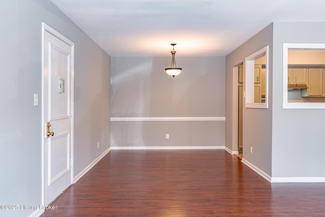 interior space featuring dark wood-style floors and baseboards