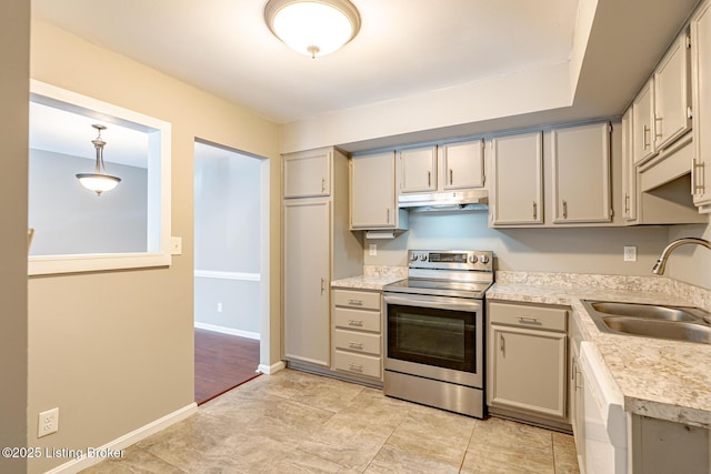 kitchen with stainless steel electric stove, light countertops, white dishwasher, a sink, and under cabinet range hood