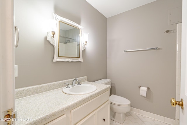 bathroom with baseboards, toilet, tile patterned flooring, walk in shower, and vanity