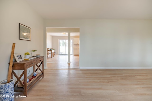 spare room with light wood-type flooring and baseboards