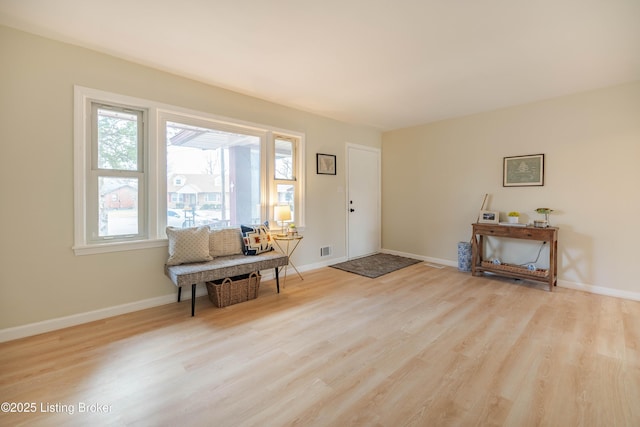 foyer entrance with visible vents, baseboards, and wood finished floors