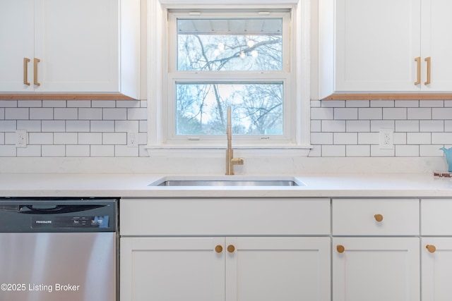 kitchen with tasteful backsplash, white cabinetry, a sink, and stainless steel dishwasher