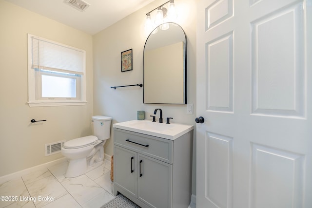 half bath featuring toilet, marble finish floor, baseboards, and visible vents