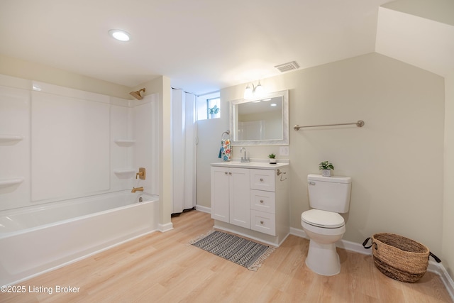 full bathroom featuring shower / tub combination, toilet, wood finished floors, visible vents, and vanity