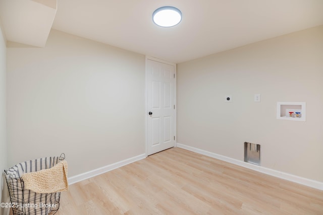 laundry room featuring laundry area, baseboards, light wood-style flooring, hookup for an electric dryer, and washer hookup