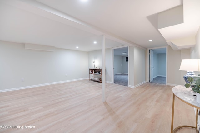 finished basement featuring light wood finished floors, baseboards, and recessed lighting