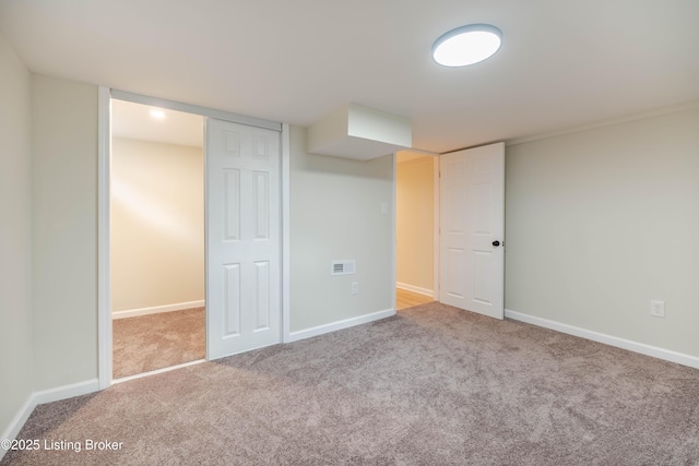 finished basement with carpet flooring, visible vents, and baseboards