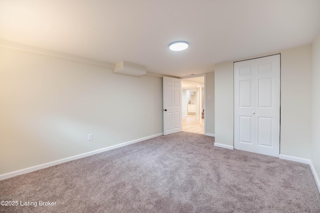 unfurnished bedroom with carpet floors, a closet, and baseboards