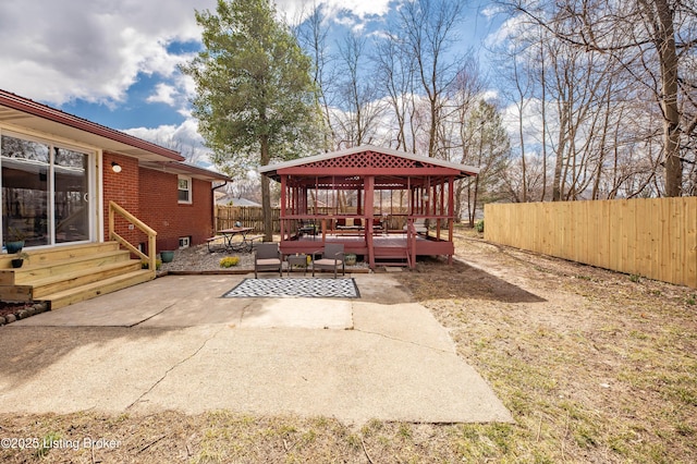 view of patio / terrace featuring entry steps, fence, and a deck