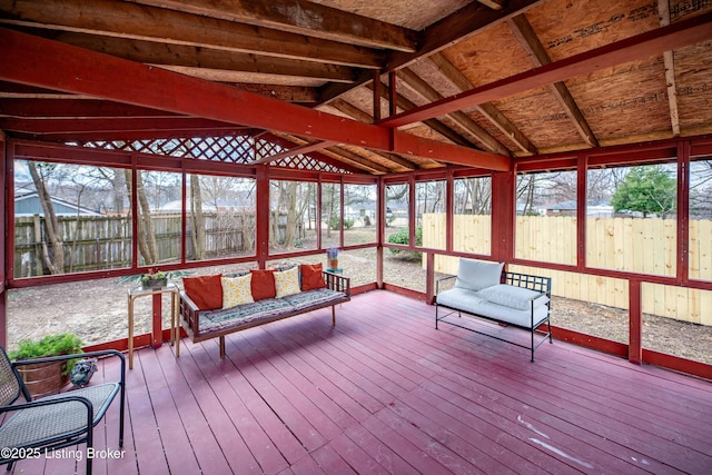 unfurnished sunroom with lofted ceiling