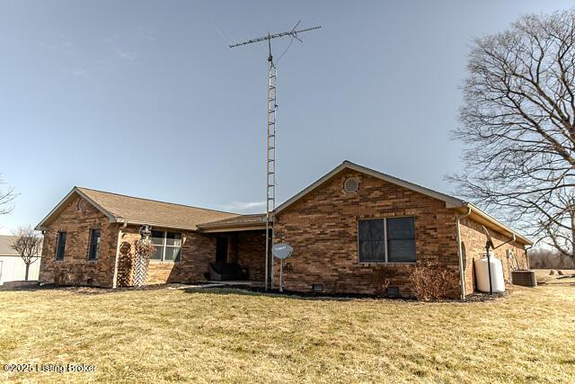 ranch-style home with crawl space, a front lawn, cooling unit, and brick siding