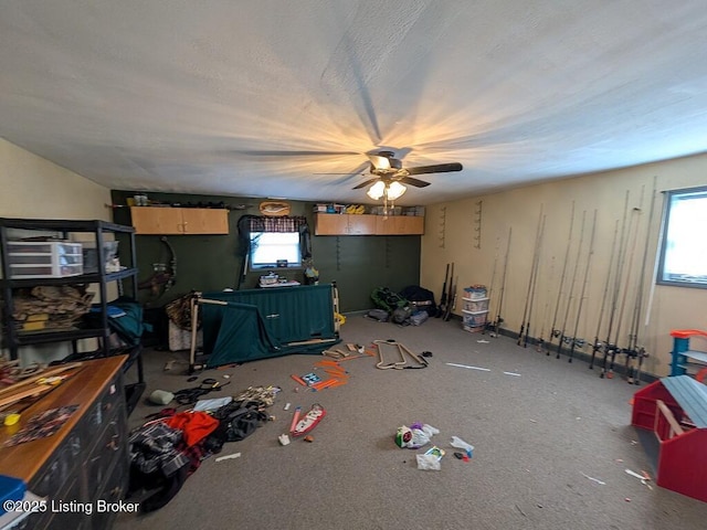interior space featuring a textured ceiling, a ceiling fan, and a healthy amount of sunlight