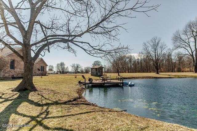 exterior space featuring a water view and a lawn