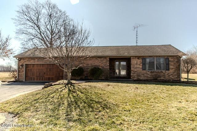 ranch-style home with driveway, an attached garage, french doors, a front lawn, and brick siding
