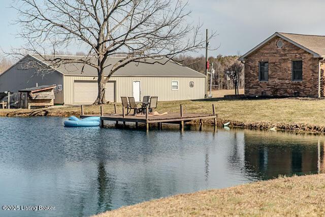 exterior space featuring a lawn and a water view