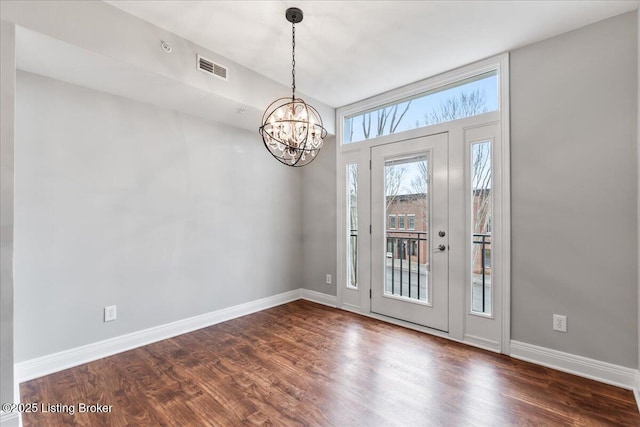 foyer entrance featuring visible vents, baseboards, and dark wood-style flooring