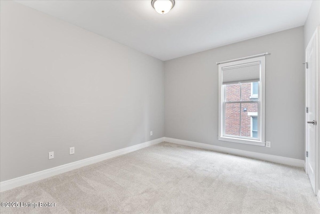 carpeted empty room with baseboards