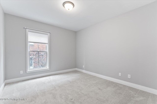 carpeted empty room with baseboards