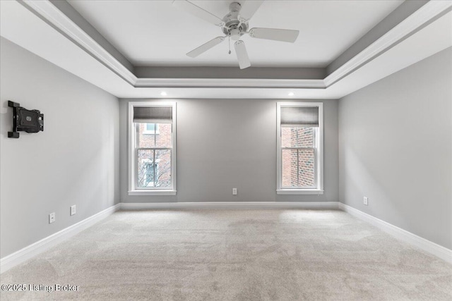 empty room featuring baseboards, carpet, a healthy amount of sunlight, and ceiling fan