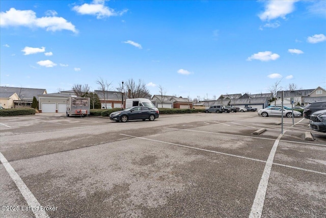 uncovered parking lot with a residential view