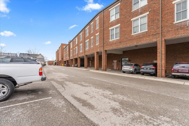 view of building exterior with uncovered parking