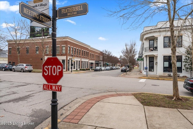 view of street featuring sidewalks, curbs, and traffic signs