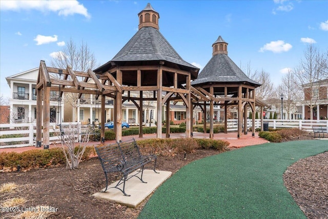 view of home's community with a gazebo and fence