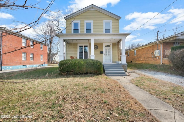 view of front of property with a front lawn and covered porch