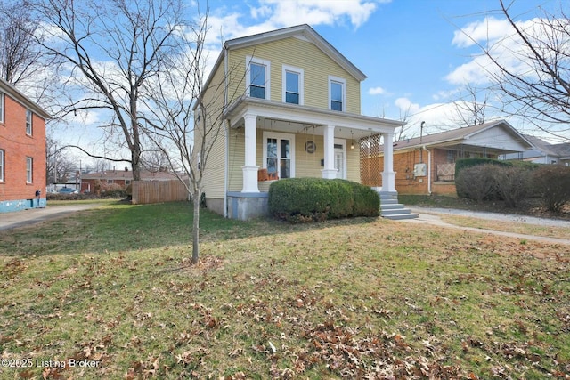 view of front facade with covered porch and a front lawn