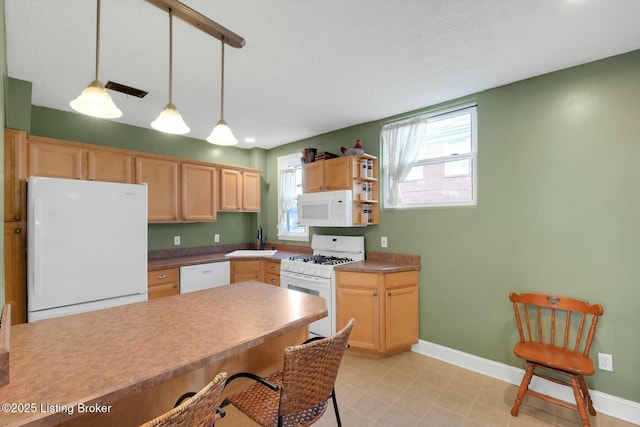 kitchen featuring light brown cabinets, white appliances, pendant lighting, and baseboards