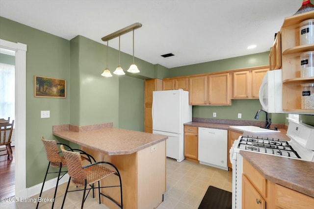 kitchen featuring light brown cabinetry, white appliances, a kitchen breakfast bar, and open shelves