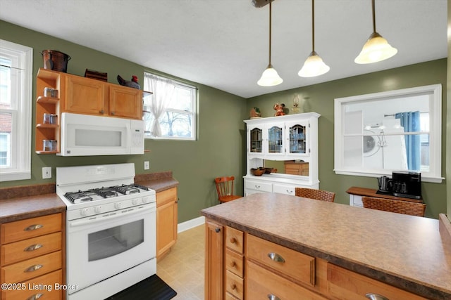 kitchen featuring decorative light fixtures, white appliances, baseboards, and open shelves