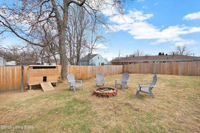 view of yard with a fire pit and a fenced backyard