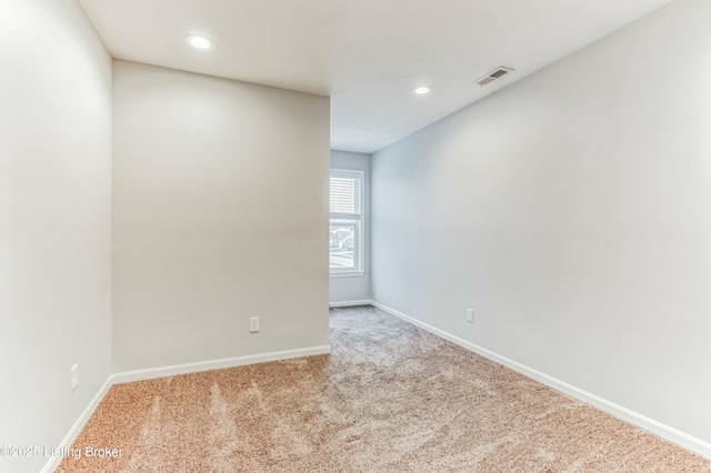 empty room with baseboards, visible vents, carpet flooring, and recessed lighting