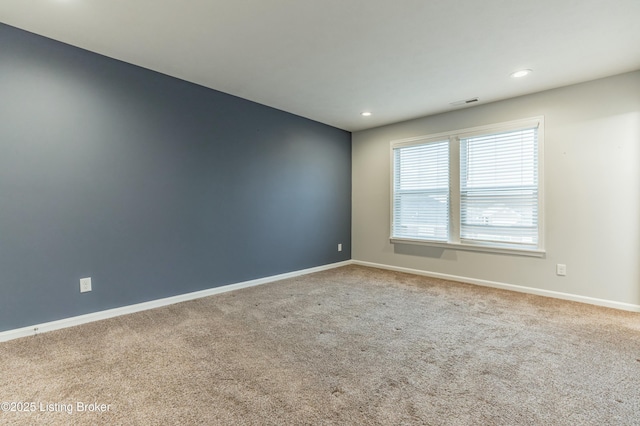 empty room featuring recessed lighting, carpet flooring, visible vents, and baseboards