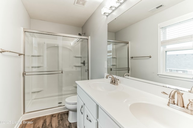 full bath with a shower stall, visible vents, and a sink