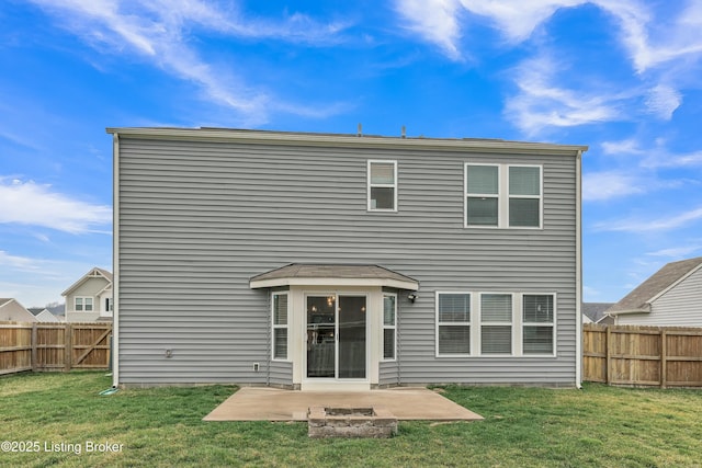 back of house with a fenced backyard, a patio, and a lawn