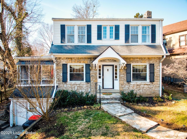 view of front of house featuring stone siding and a chimney