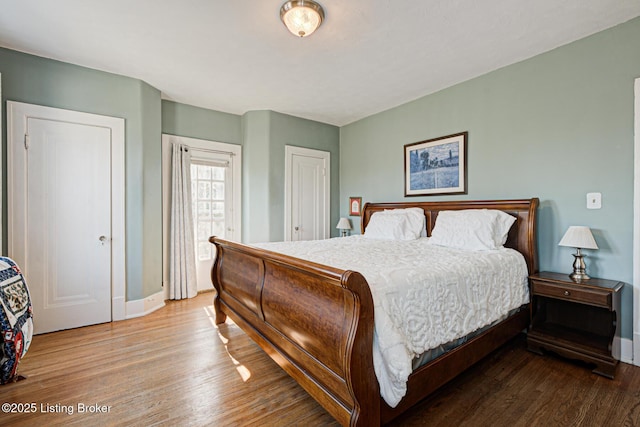 bedroom featuring baseboards and wood finished floors