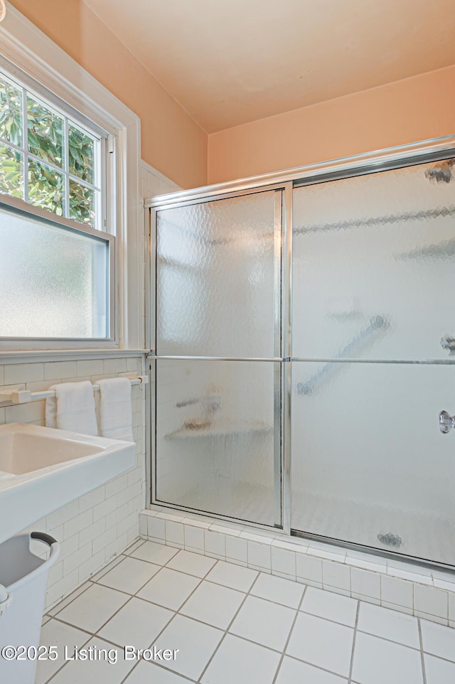 full bath with a stall shower and tile patterned floors