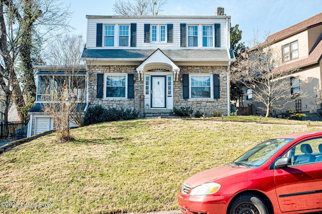 view of front facade with a front lawn, fence, and stone siding
