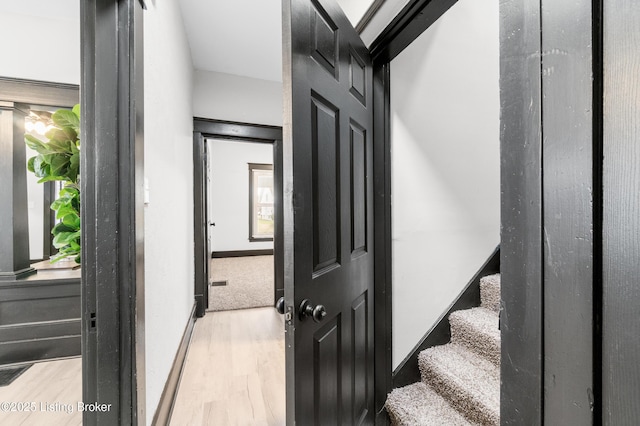 stairway with baseboards and wood finished floors