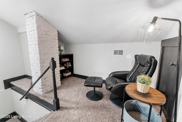 sitting room with carpet, lofted ceiling, visible vents, an upstairs landing, and baseboards